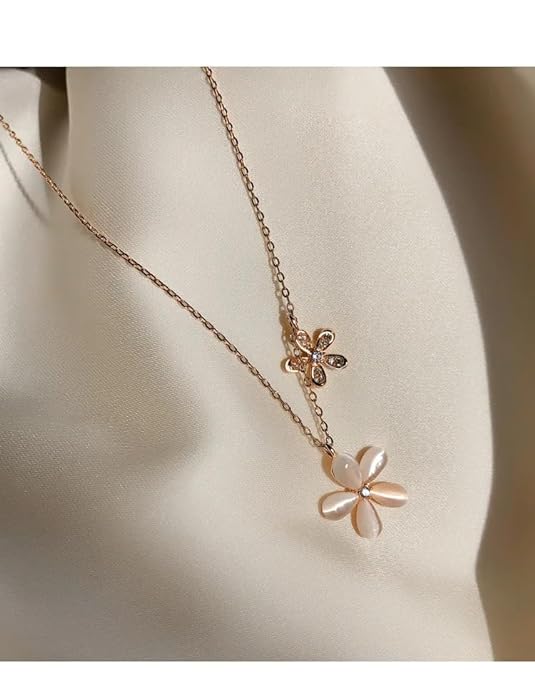 A necklace adorned with a pink and white flower.