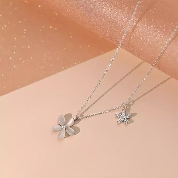 Dainty silver necklace adorned with a flower.