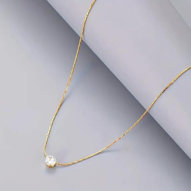 A gold plated necklace with a sparkling diamond stone.