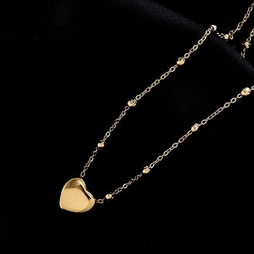 Dainty gold heart necklace with a matching chain.