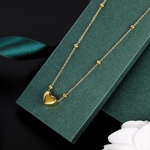 Elegant gold heart pendant on a gold chain.