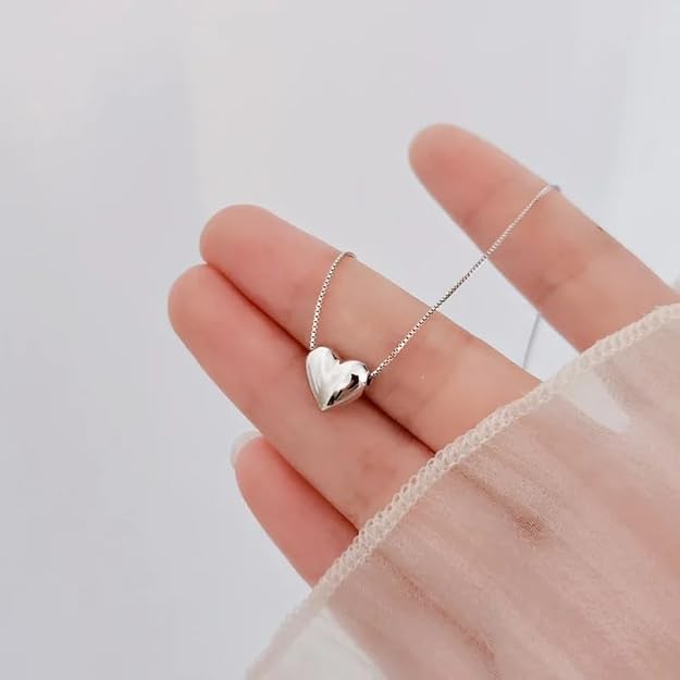 A beautifully crafted heart pendant hangs from a sleek silver chain, representing elegance and romantic sentiment.