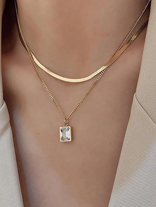 Stunning gold necklace featuring square pendant, packaged in a gift box.