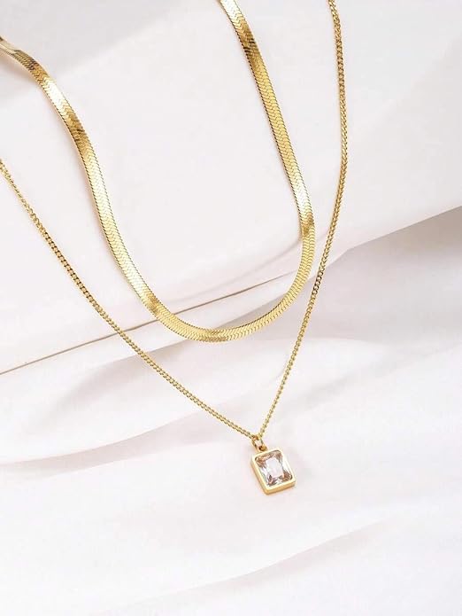 Exquisite gold necklace with square pendant, elegantly boxed for gifting.