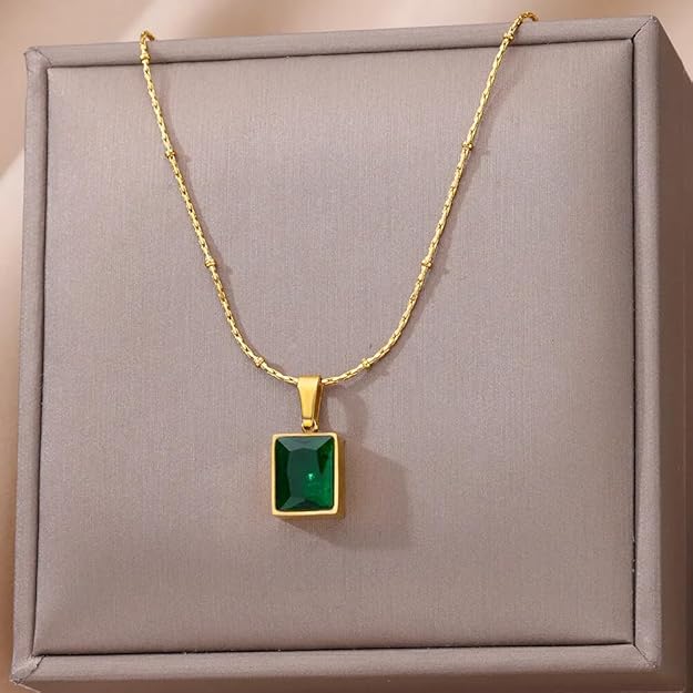 Elegant gold plated pendant featuring a square design and a stunning emerald stone.