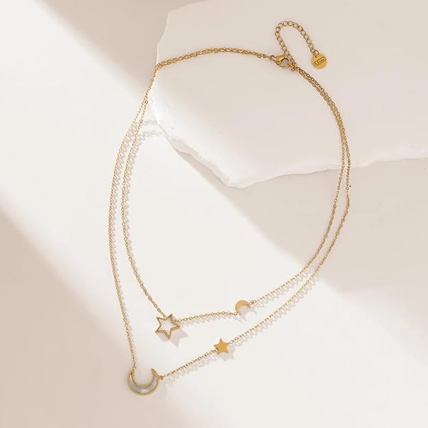 Stylish gold necklace with multiple layers of chains, each embellished with stars and moon pendants for a celestial touch.