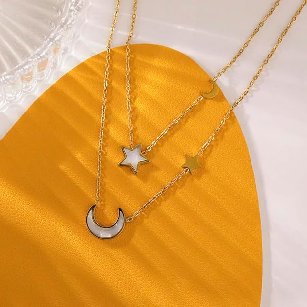 Add a celestial flair to your ensemble with this stunning gold necklace, designed with layers of chains and star and moon accents.