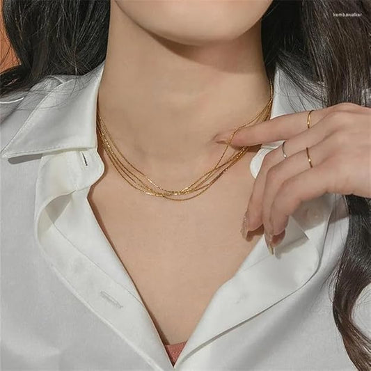 Elegant gold chain necklace neatly presented in a brown box.