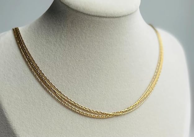 Stylish gold chain necklace packaged in a sleek brown box.