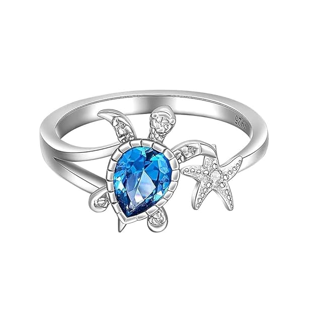 Unique ring with a turtle, blue topaz, and starfish details.