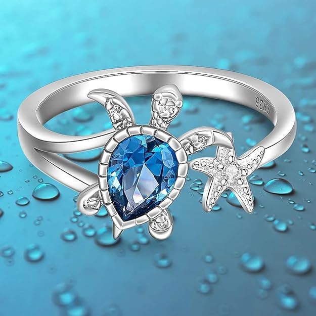 Cute turtle ring featuring blue topaz and a starfish design.