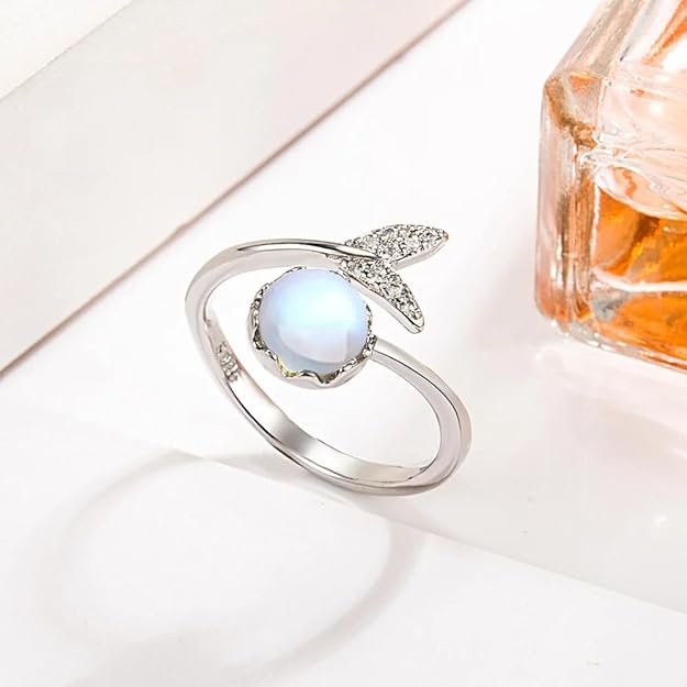 A beautiful ring adorned with a blue moonstone and a brilliant diamond.