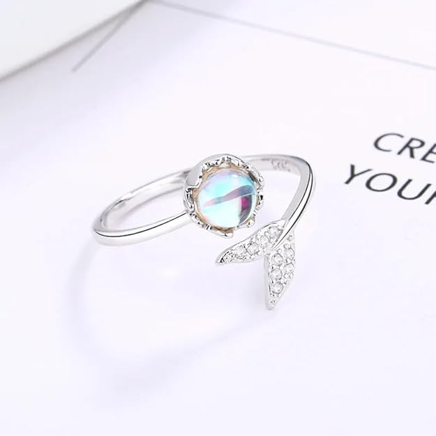 An elegant ring with a blue moonstone and a dazzling diamond.