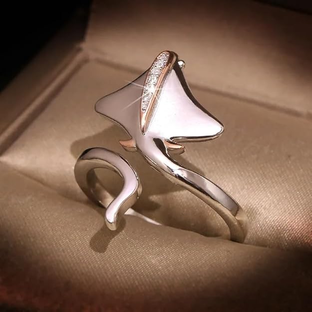 A silver ring adorned with a radiant diamond in the middle.