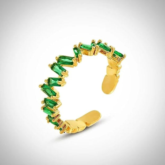 A luxurious gold ring adorned with stunning emerald stones.