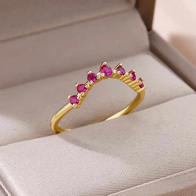 Elegant gold ring adorned with beautiful pink stones, a stunning accessory for any occasion.