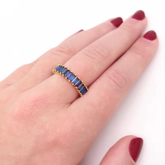  Stunning blue and gold ring adorned with a gemstone.