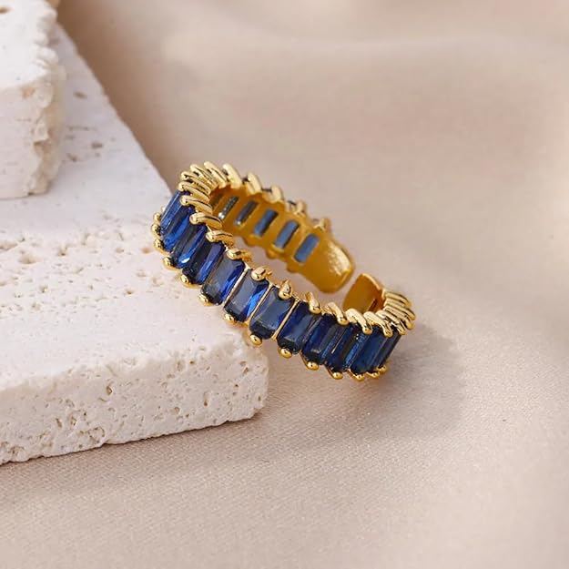 Blue and gold ring with a sparkling stone in the center.