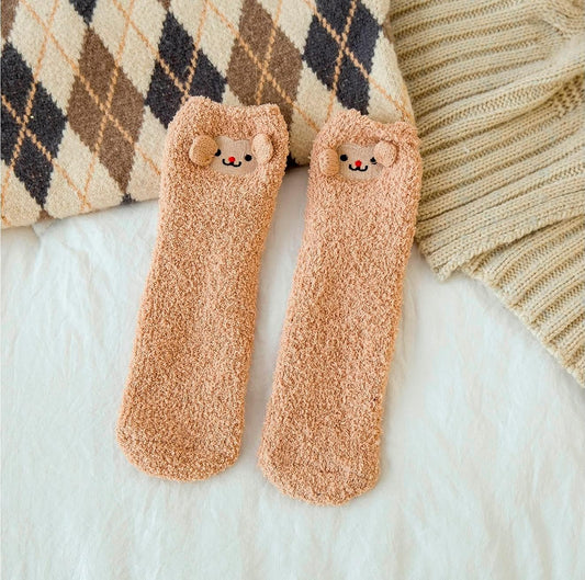 Two pairs of cozy socks featuring adorable teddy bear faces, perfect for keeping your feet warm and cheerful.