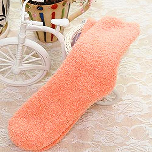 A pair of vibrant orange socks neatly placed on a wooden table, showcasing their bright color and soft texture.
