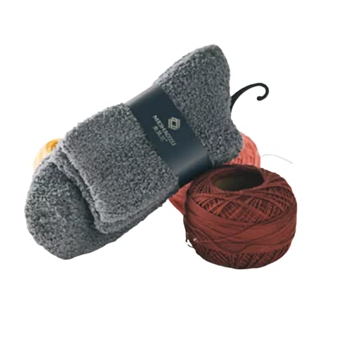 A cozy pair of socks and colorful yarn resting on a clean white surface, perfect for a crafting project.