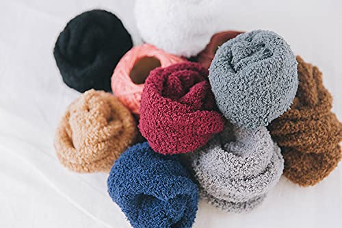 A cheerful individual enjoying a moment of comfort in their soft, grey fuzzy socks, perfect for a cozy day indoors.
