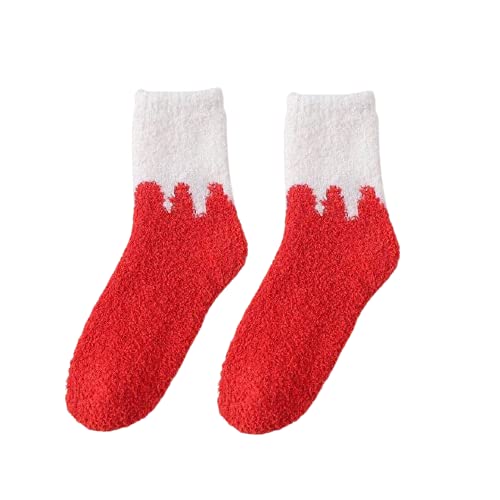 A cozy pair of red and white socks covered in soft white snow, perfect for winter vibes.