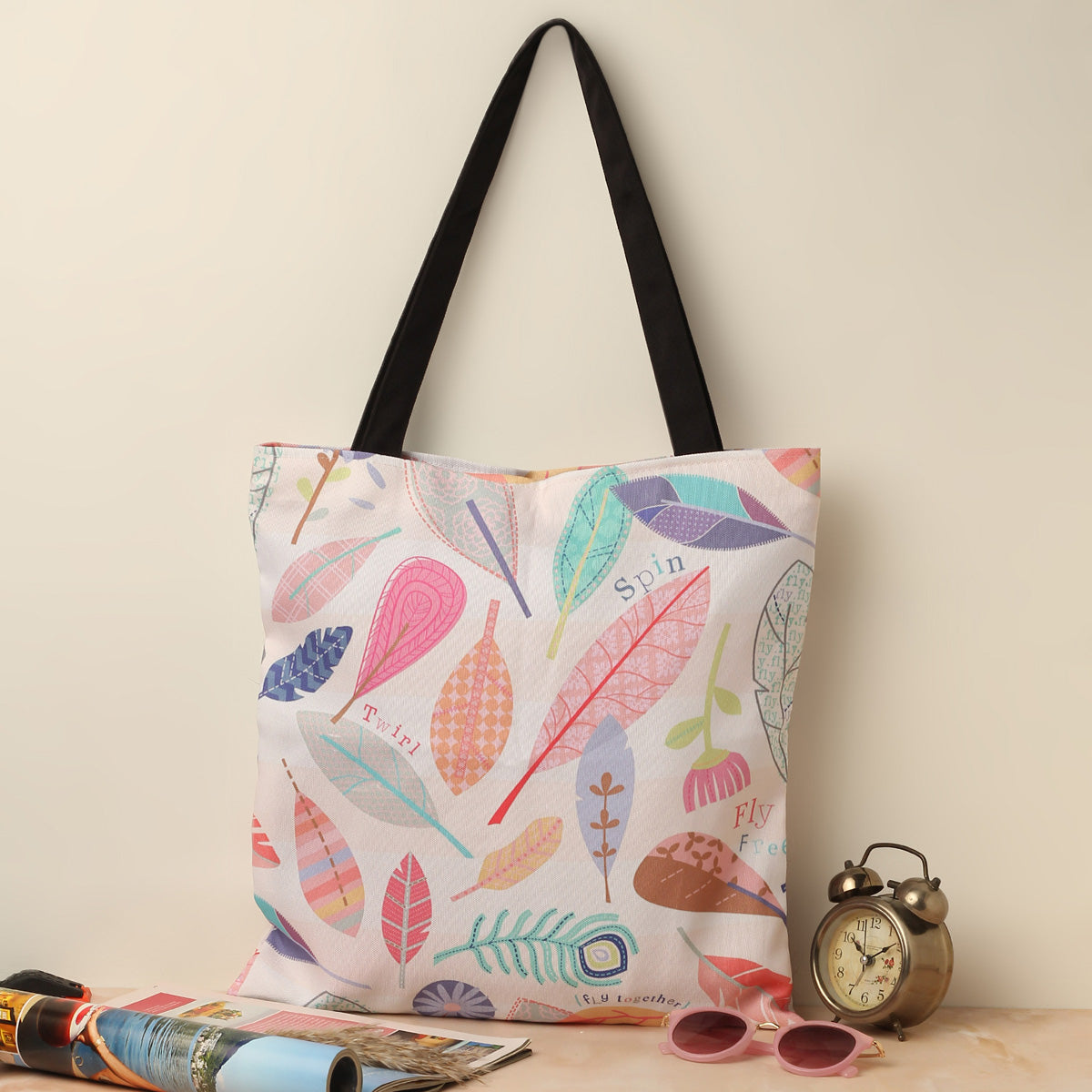 Colorful tote bag with leaf pattern, perfect for carrying essentials on a sunny day out.