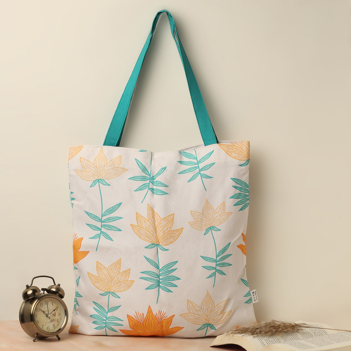 A tote bag featuring a colorful flower pattern, perfect for carrying essentials on a sunny day out.