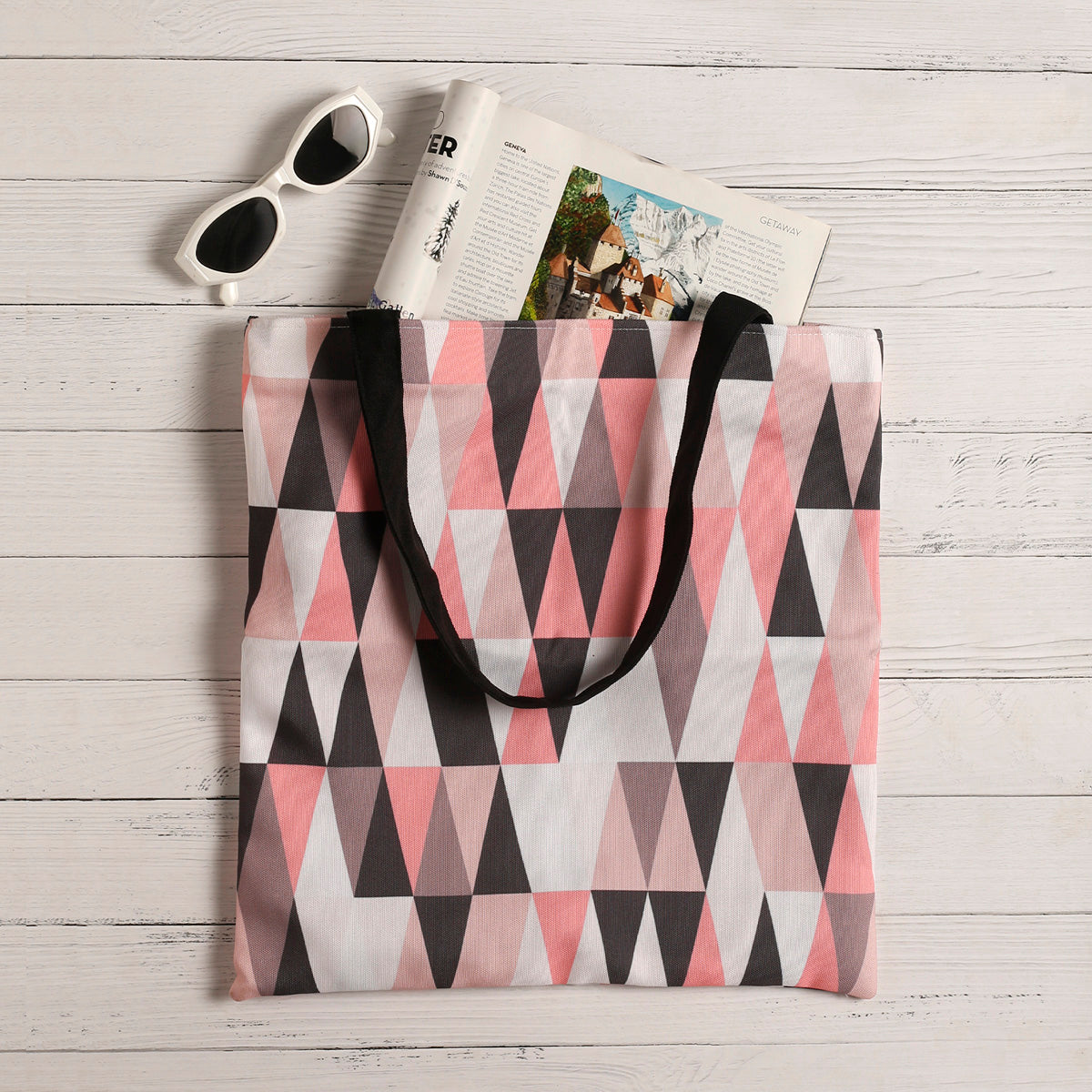 Trendy tote bag with pink and black triangles.