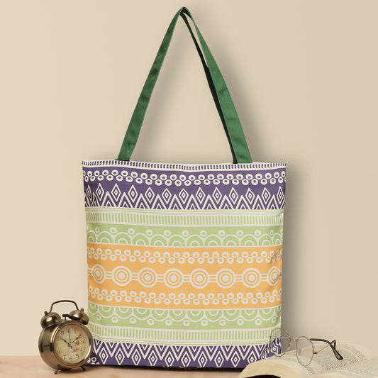 Colorful tote bag with green handle, perfect for carrying essentials on a sunny day out.