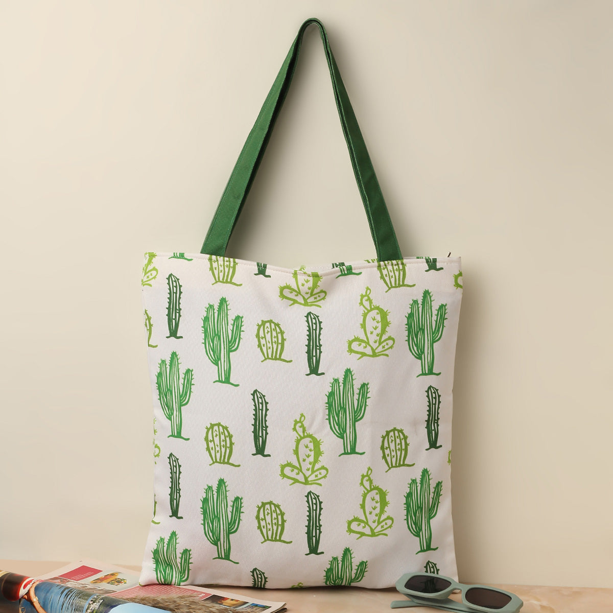  A green and white tote bag with a cute cactus print.