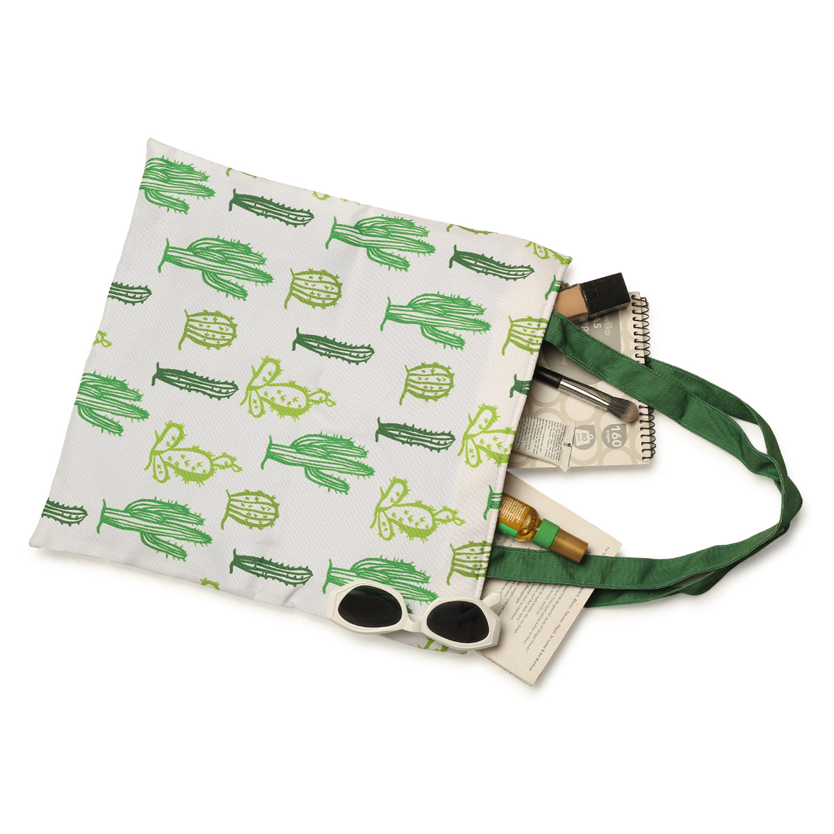 A trendy green and white tote bag adorned with a playful cactus design, ideal for carrying your essentials in style.