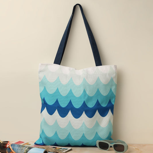  Blue and white tote bag with sunglasses and sunscreen.