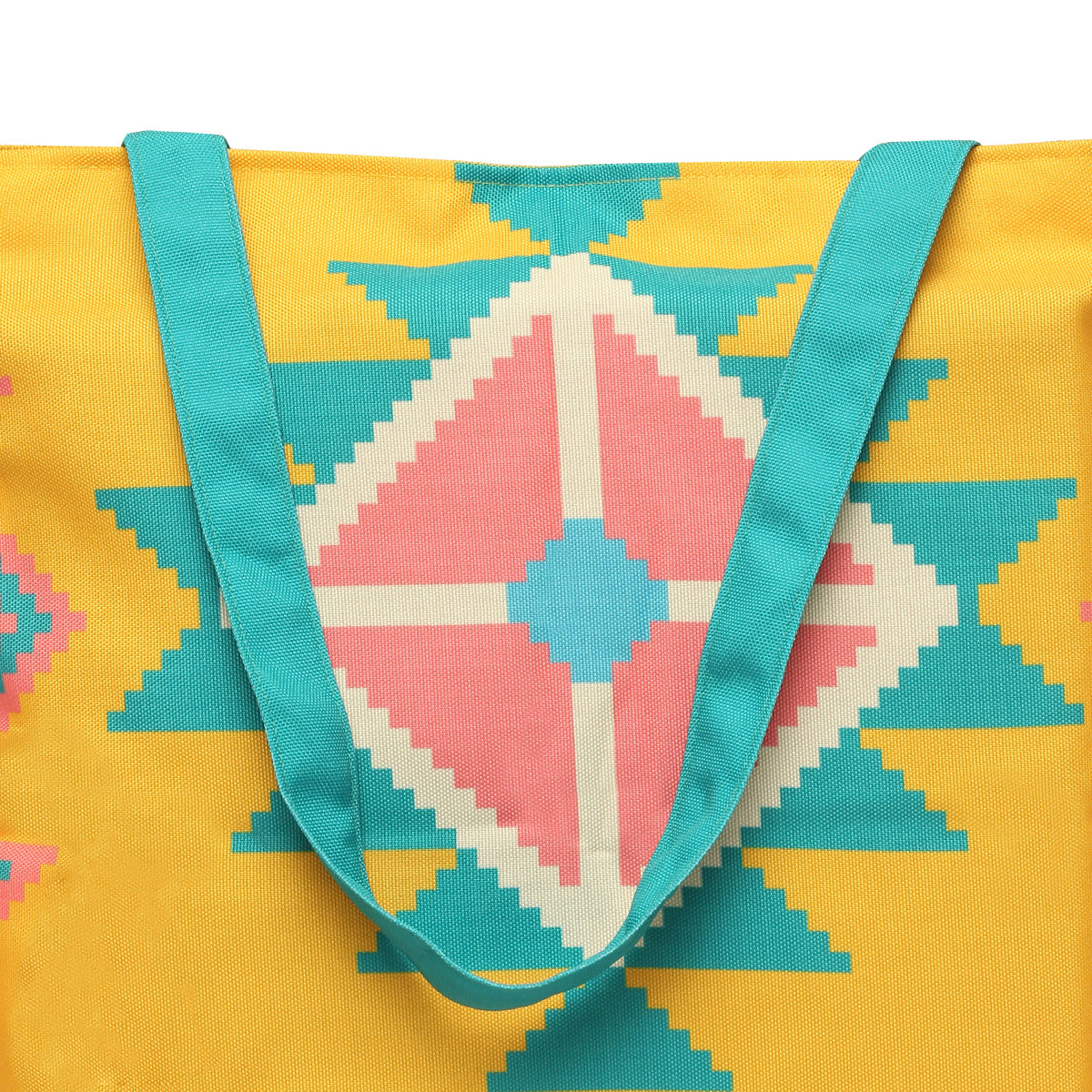 A tote bag with a pink and turquoise design, in yellow and blue.