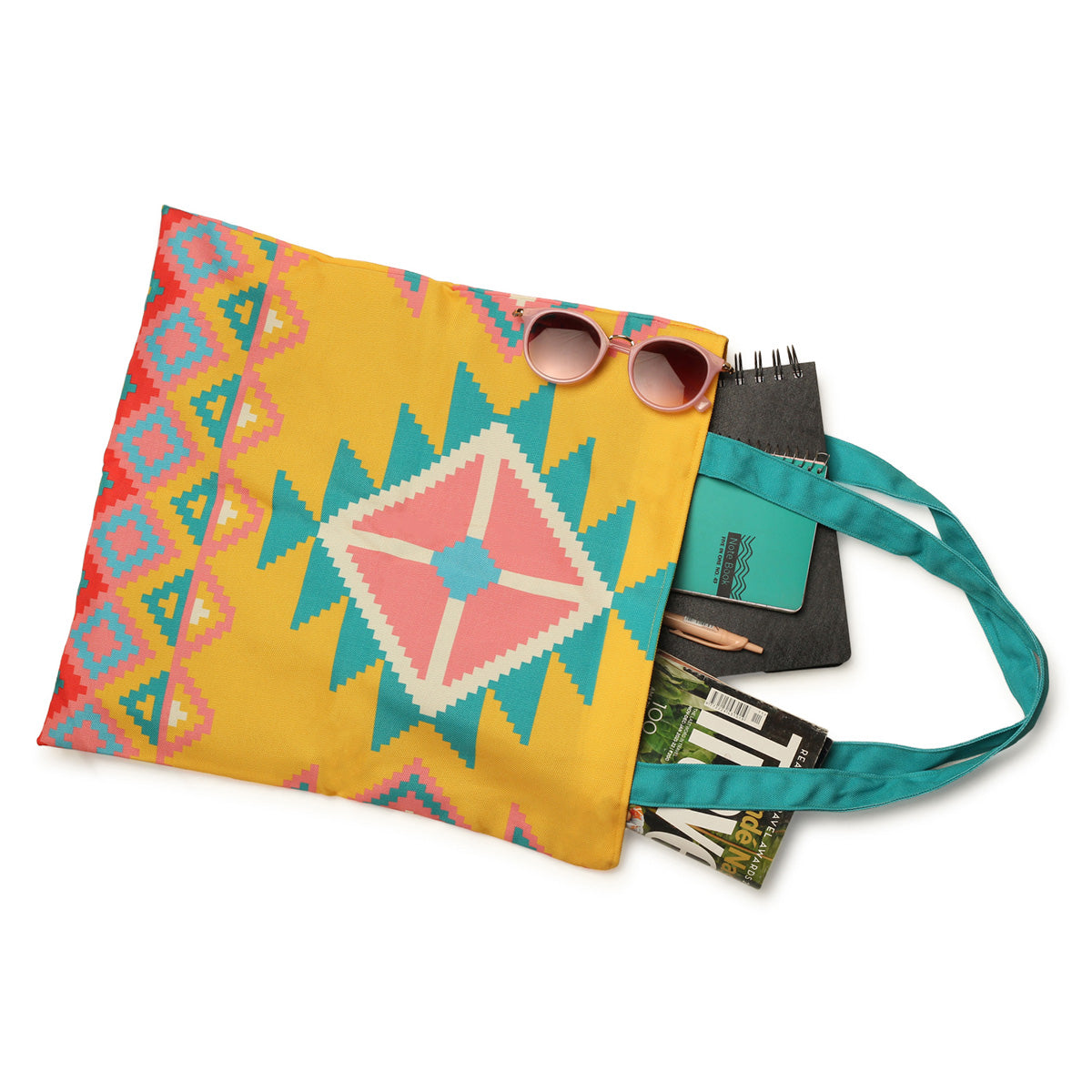 A white background showcases a yellow and blue tote bag adorned with colorful geometric designs.