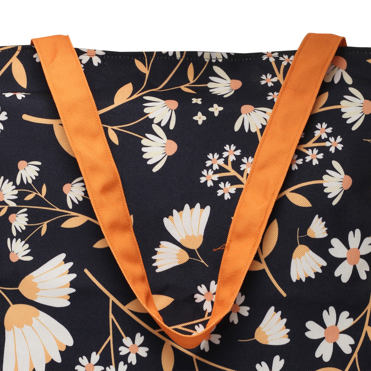 A floral print tote bag with striking orange handles.