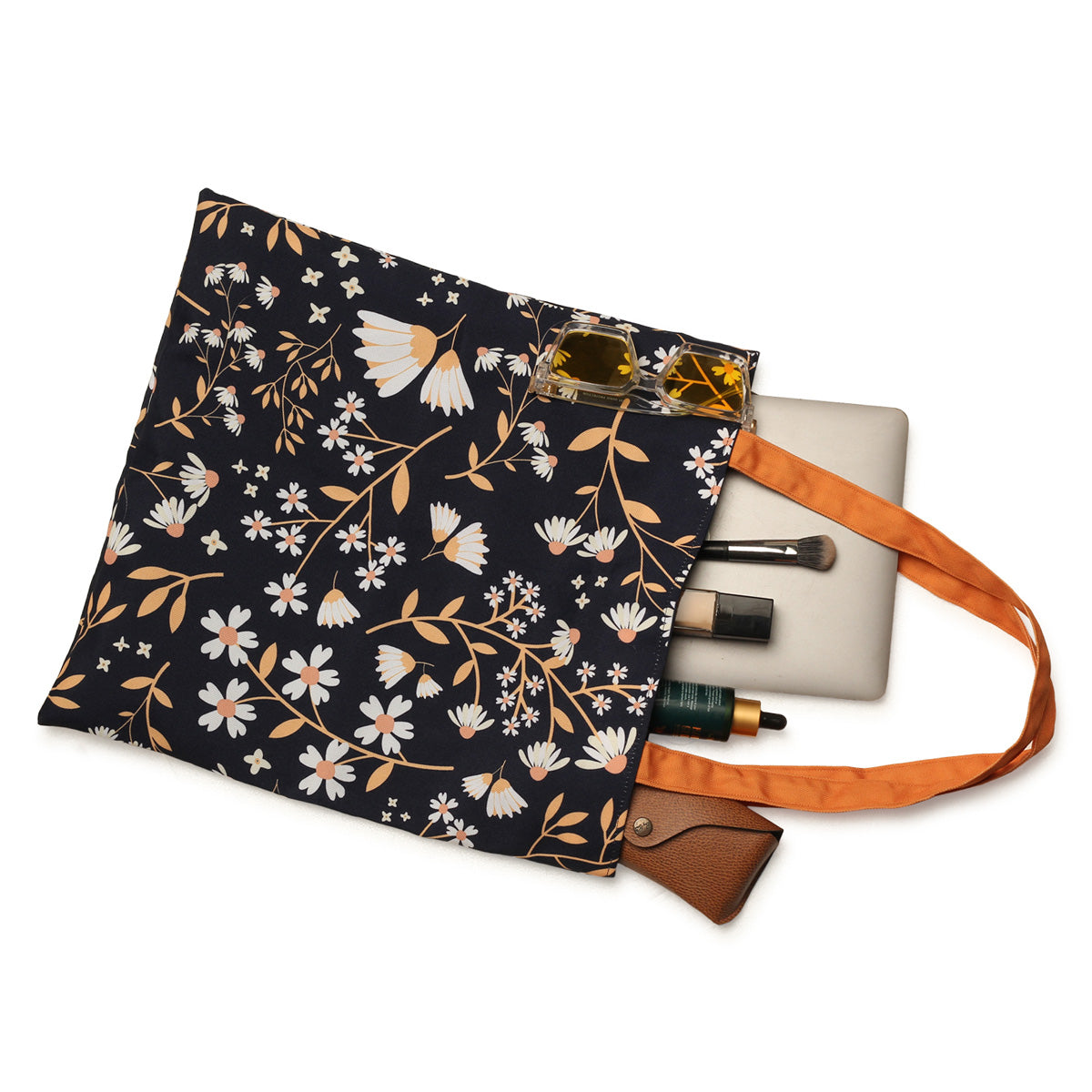 A chic tote bag adorned with a striking black and orange floral design, ideal for carrying essentials with flair.