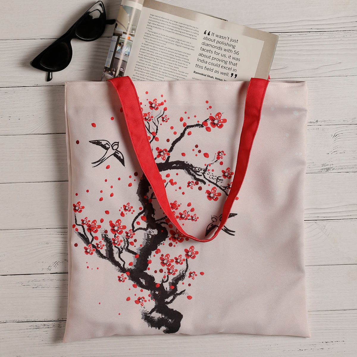 Stylish tote bag adorned with a bird and cherry blossom motif, a chic accessory for any occasion.