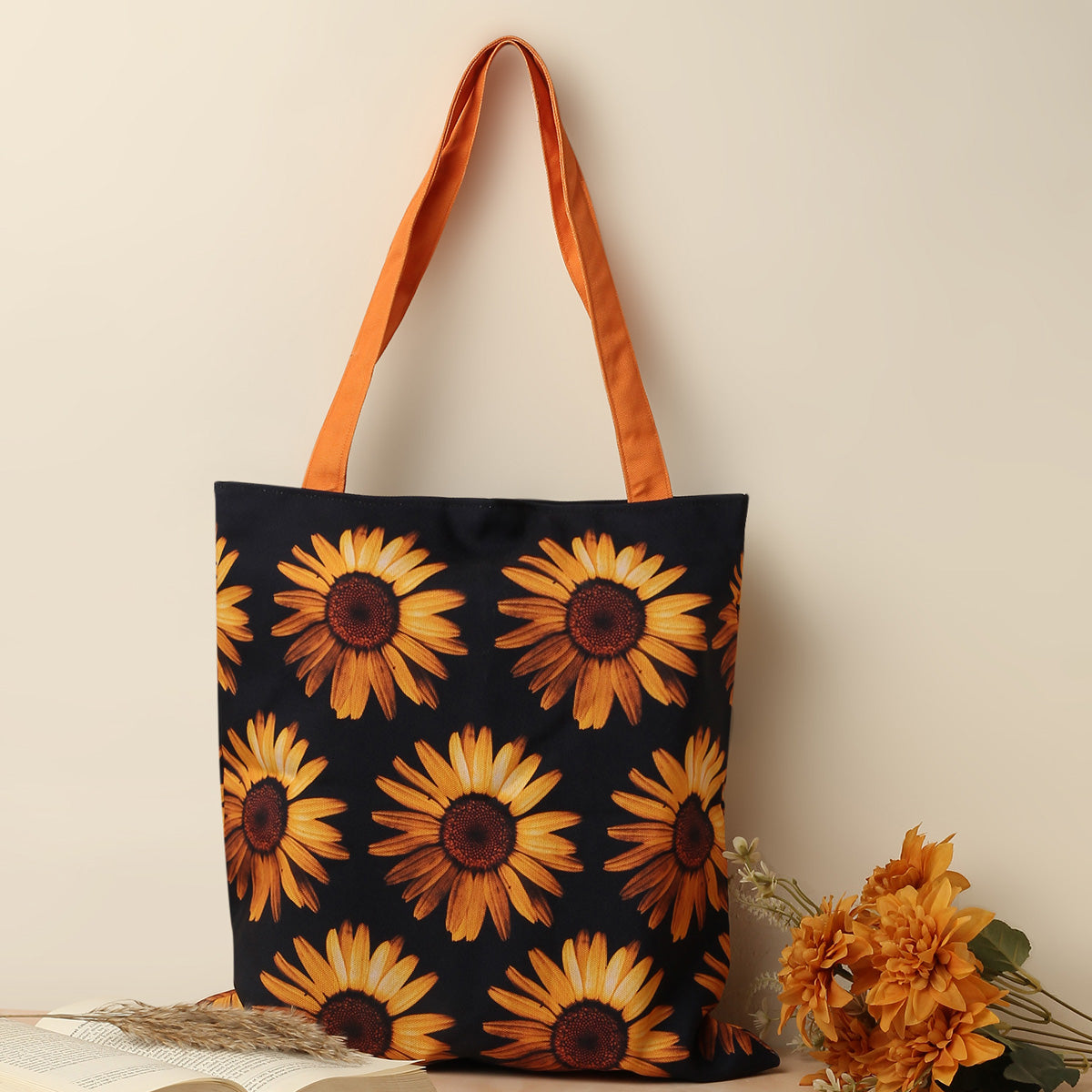 Black and orange tote bag featuring vibrant sunflowers.