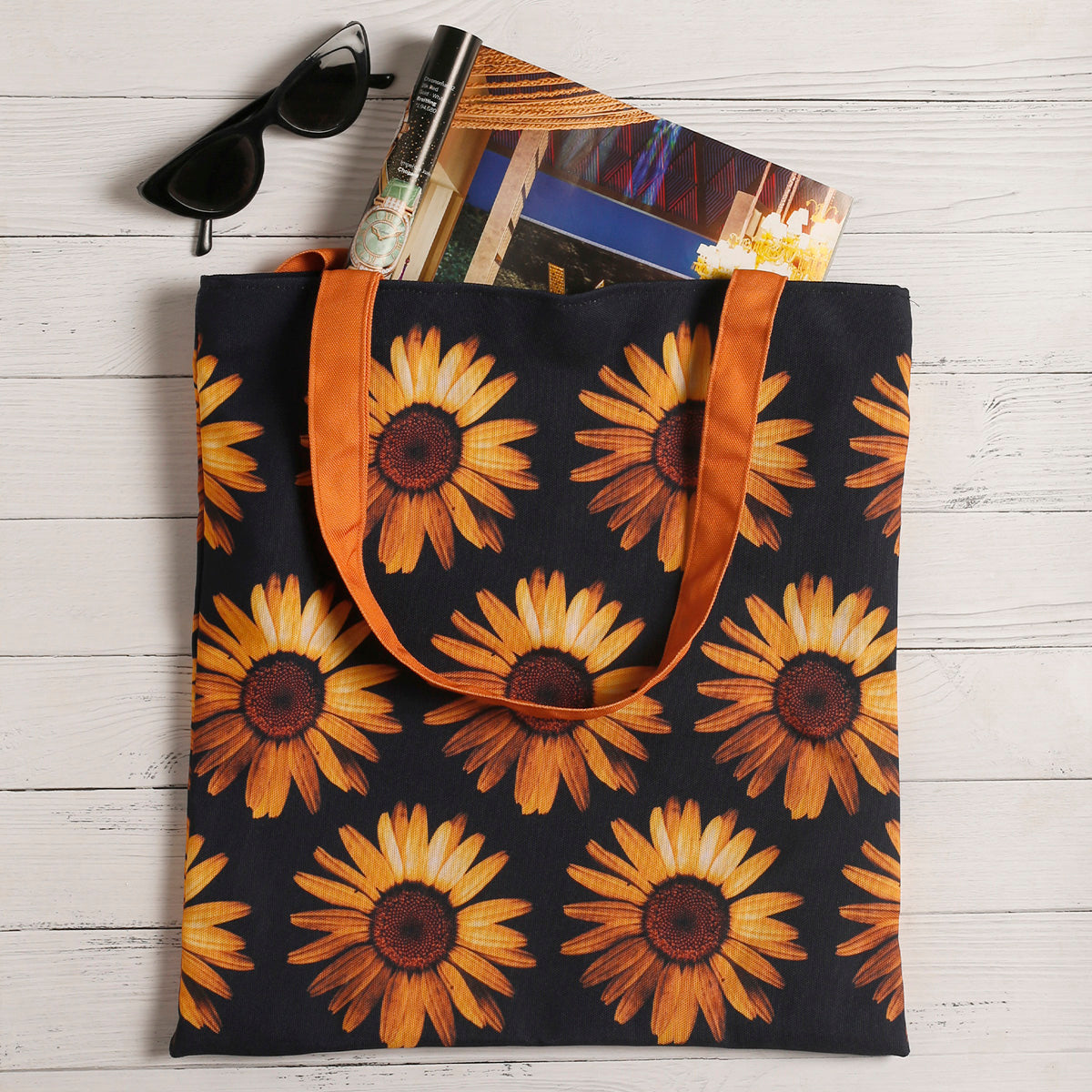 Stylish tote bag in black and orange with sunflower design.