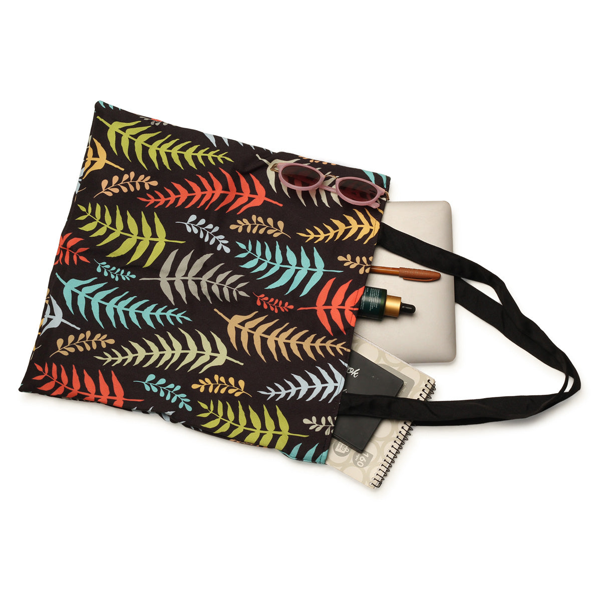 Stylish tote bag adorned with colorful leaves, a chic accessory for any occasion.