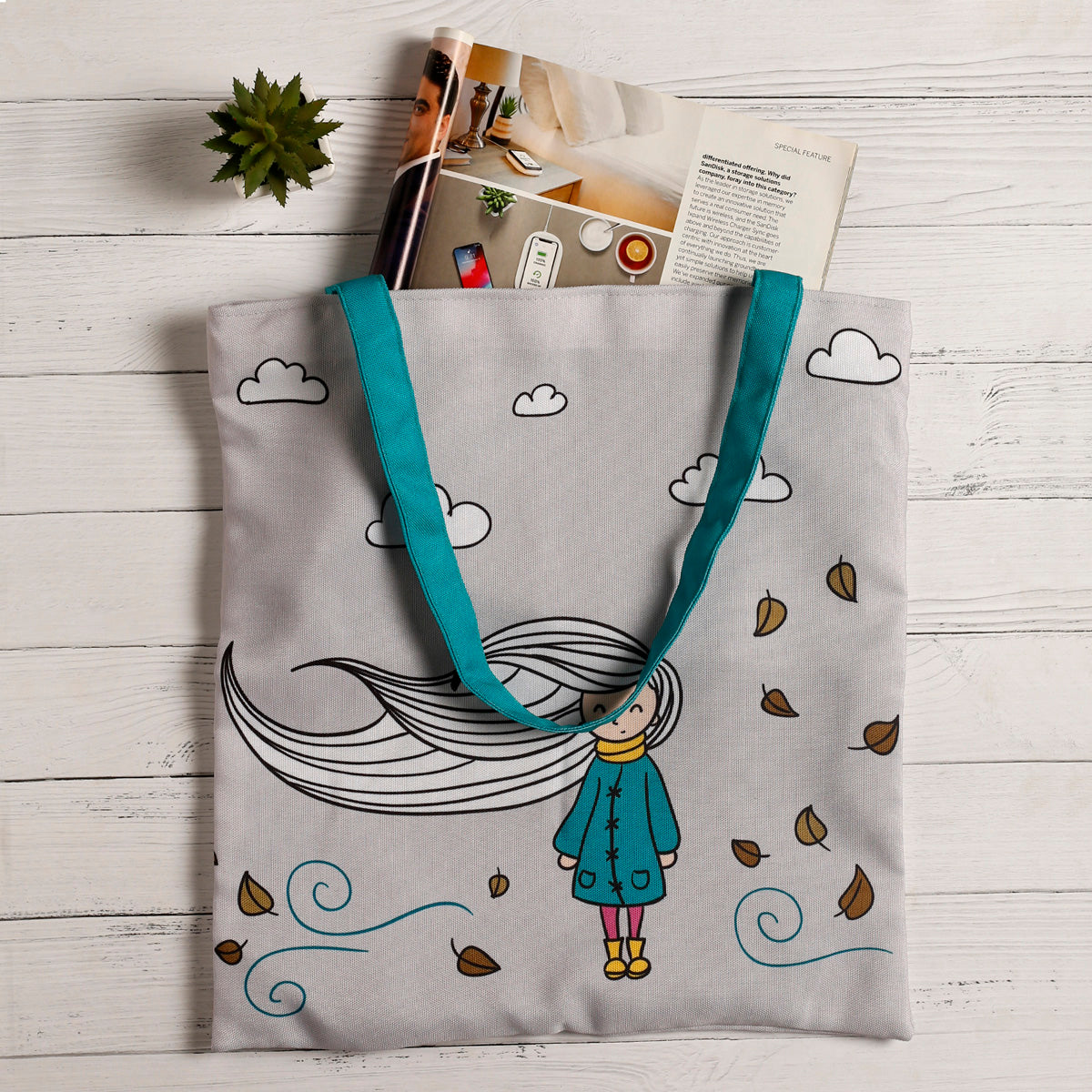 A stylish tote bag showcasing a cartoon girl playfully interacting with whimsical clouds, ideal for carrying essentials.