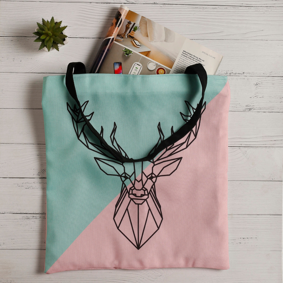  A fashionable tote bag adorned with a graceful deer illustration, ideal for carrying essentials with a touch of nature.