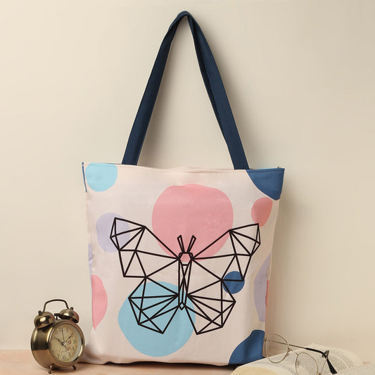  A stylish butterfly tote bag featuring a playful pink, blue, and white polka dot design, perfect for everyday use.