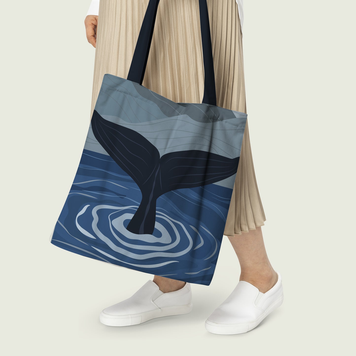 Stylish whale tote bag mockup on a beach background.