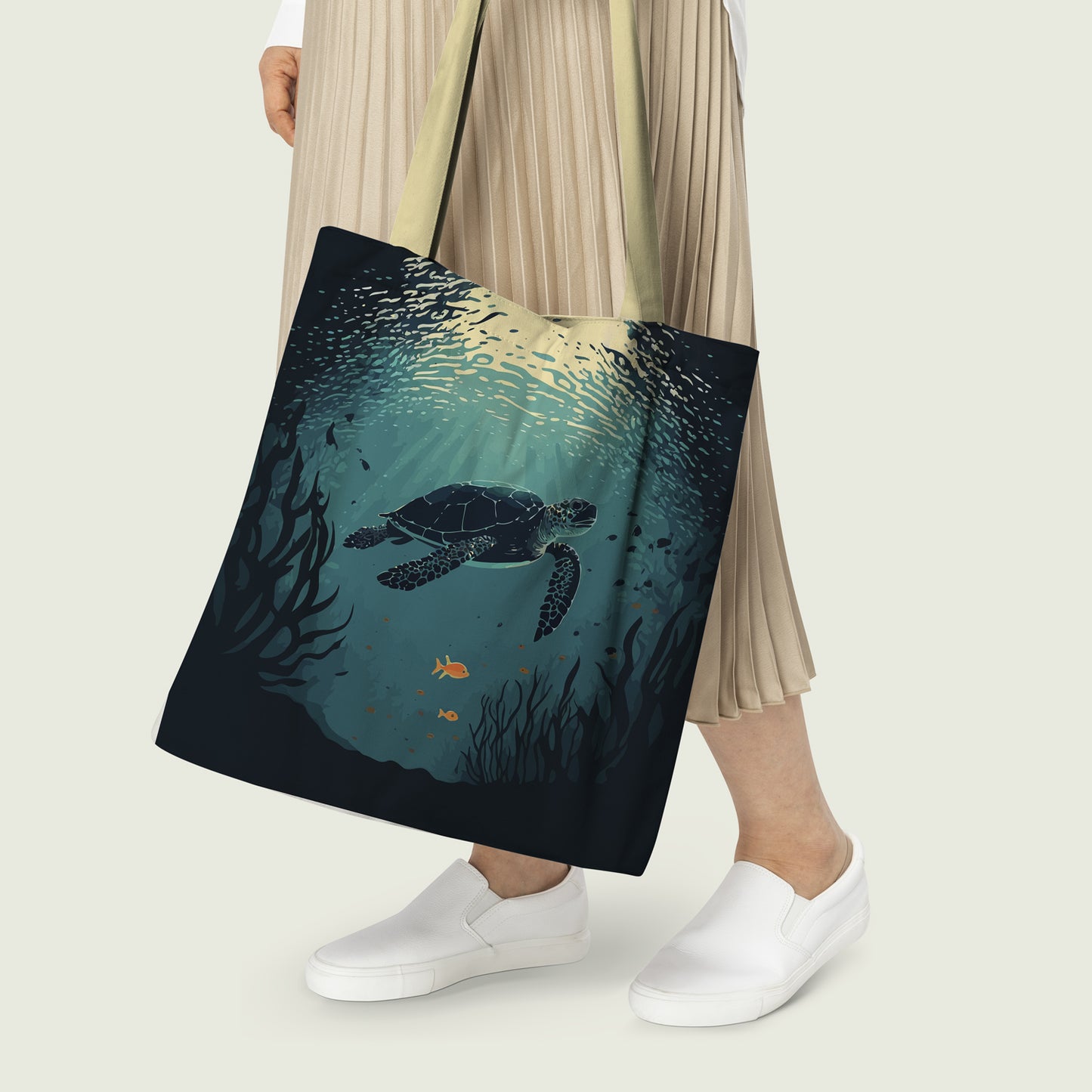  Woman holding tote bag with sea turtle image.