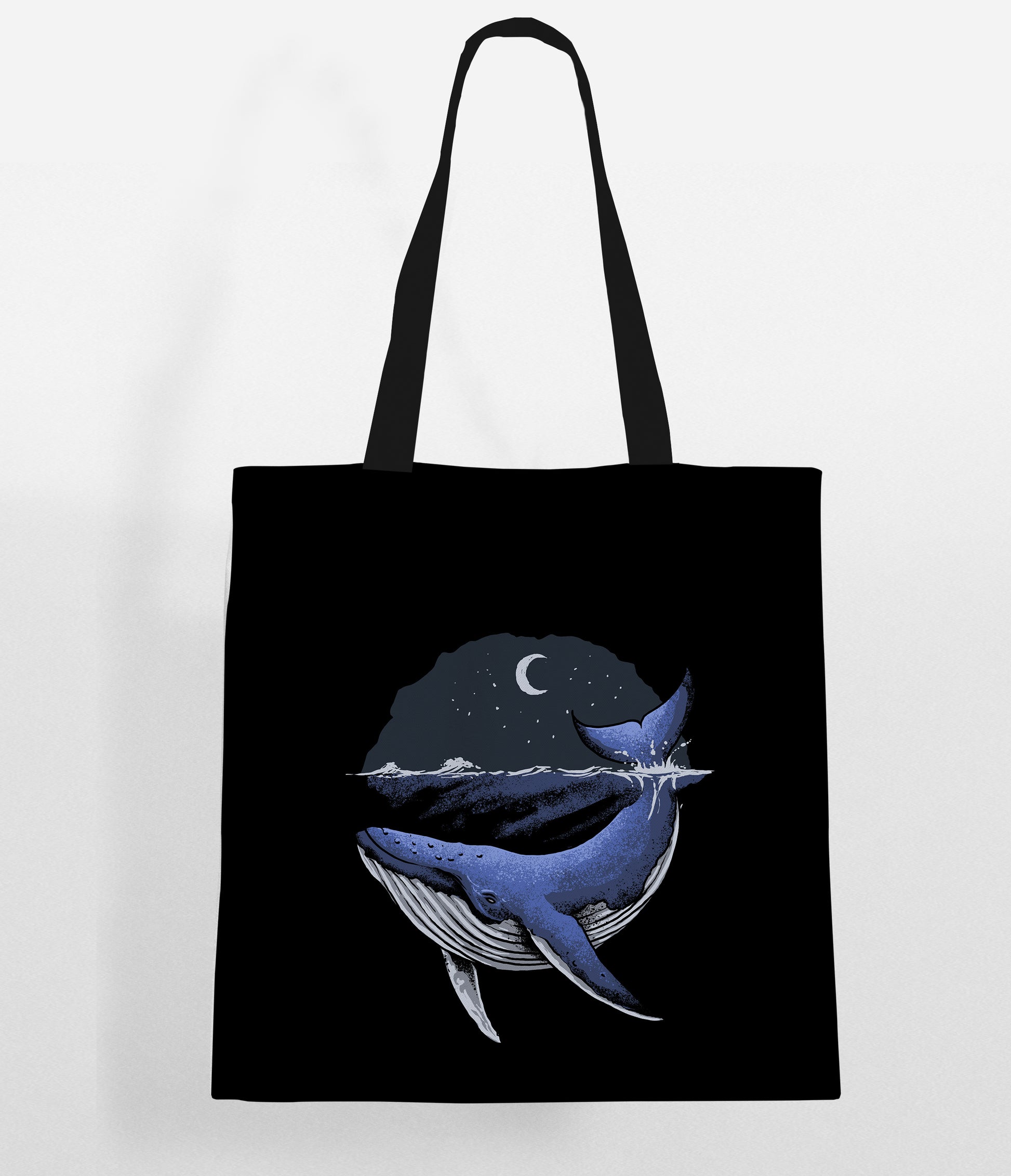 Fashionable tote bag showcasing a whale surrounded by a moon and stars motif.